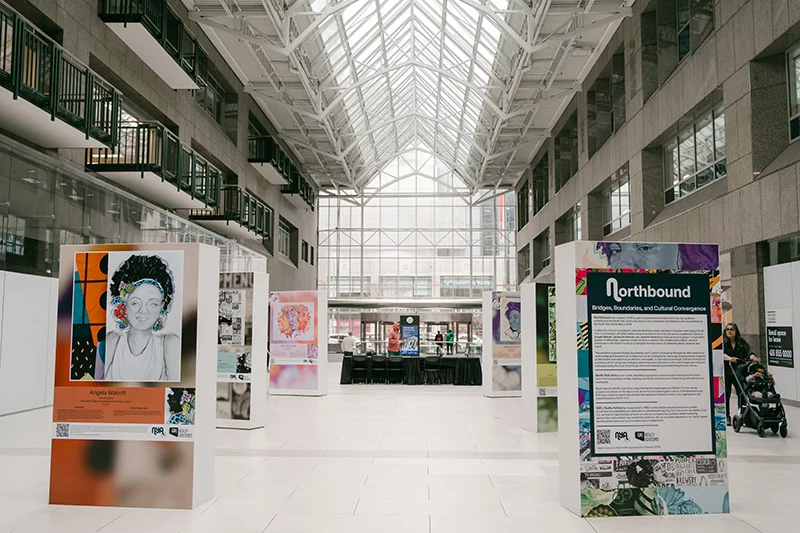 NYA 2024 Six artworks on big boxes in the atrium of the North Centre lobby. Photo by Maria Vega